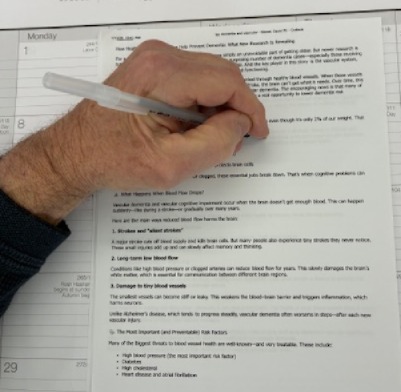 person writing with left hand