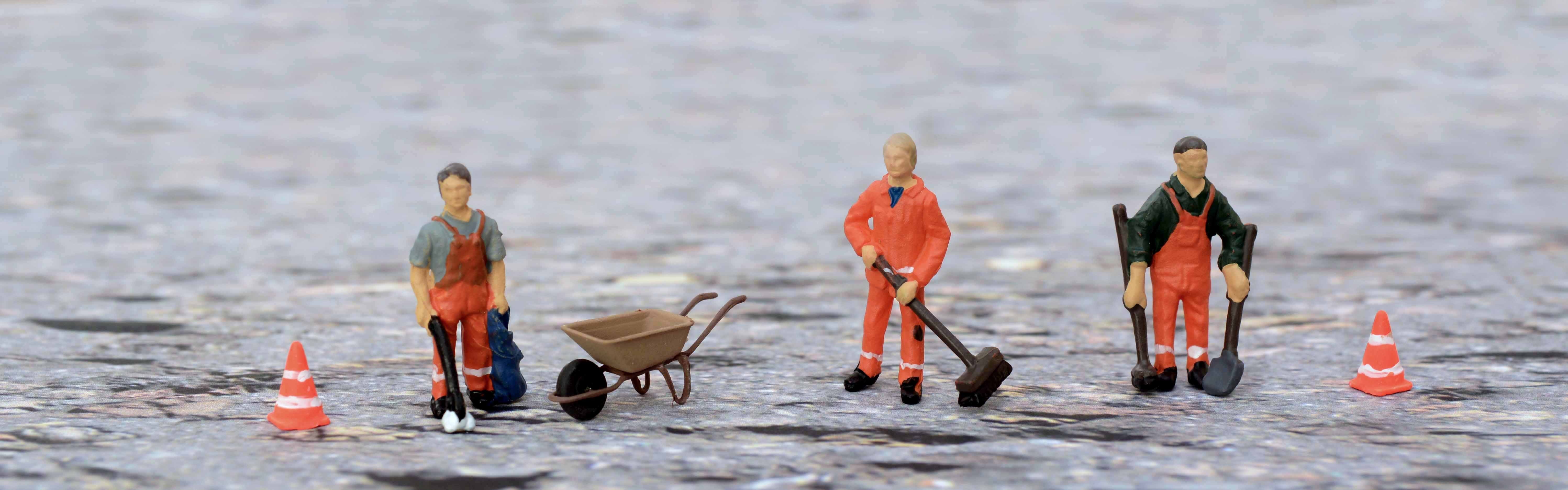 miniature figurines of men cleaning surface