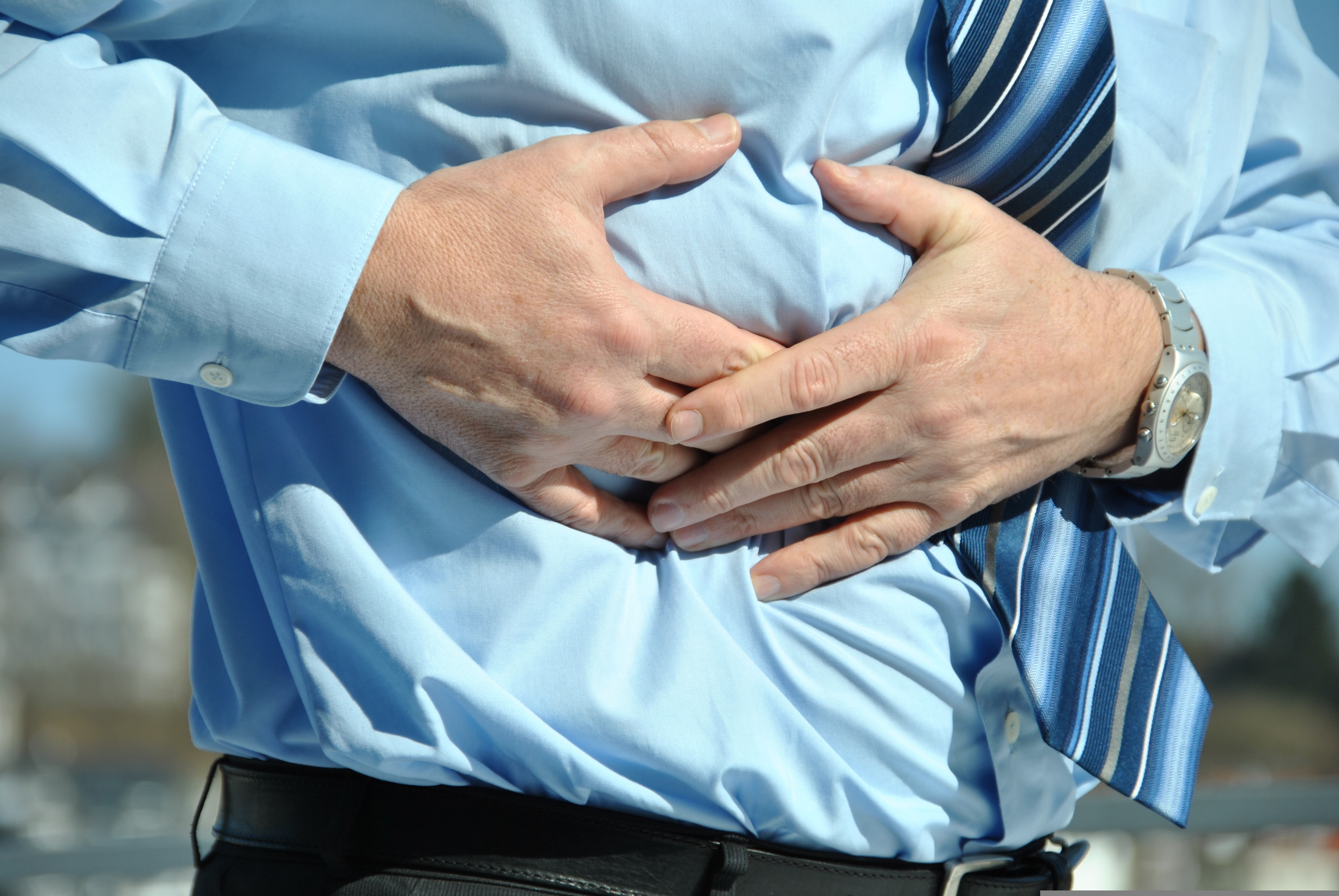 person clutching upper right quadrant of torso